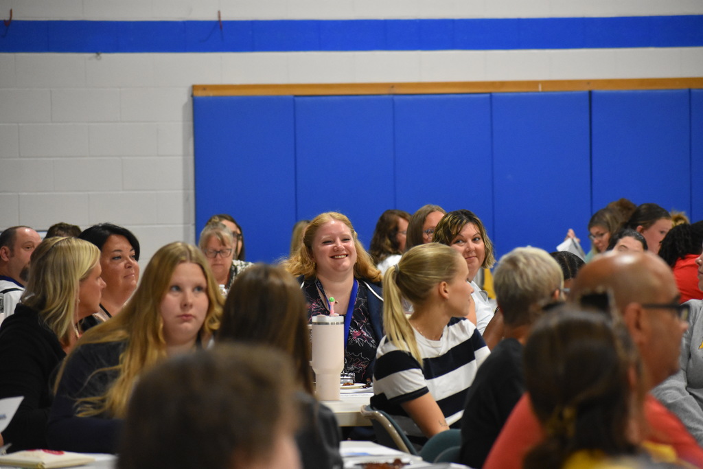 A new staff member smiling after being introduced