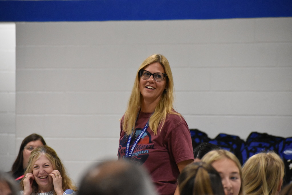 A new staff member standing after being introduced