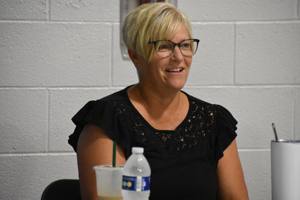 A staff member smiling during instruction