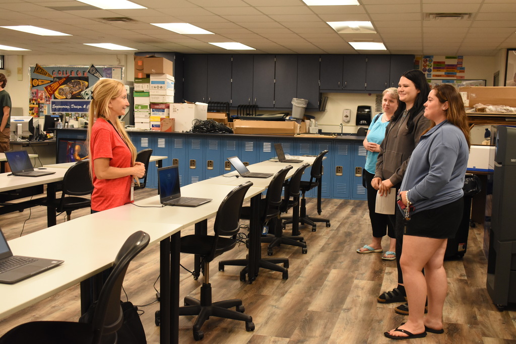 A family listening in as an instructor explains the course 
