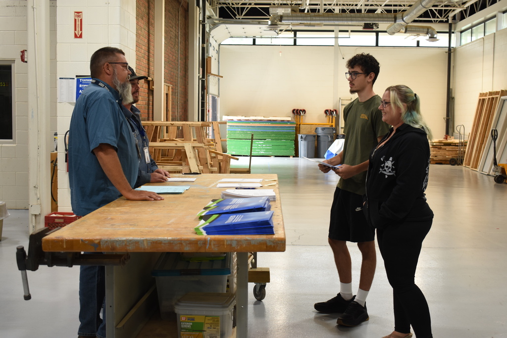 Instructors chatting with a family