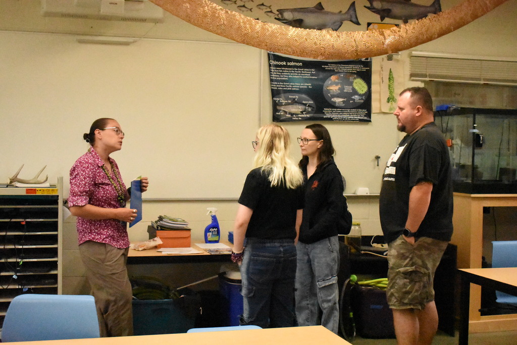 Instructors chatting with a family