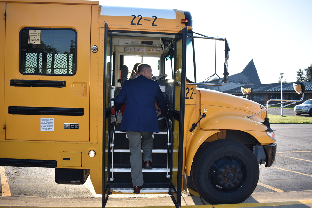 Superintendent Haag assisting with an arriving bus