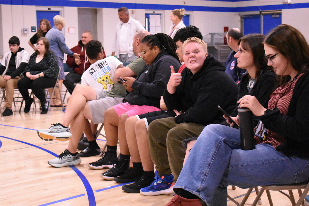 A student giving the  thumbs up at an event