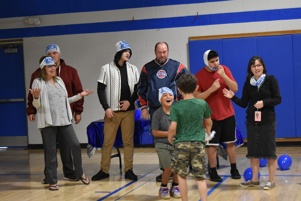 A team of people greeting their new member