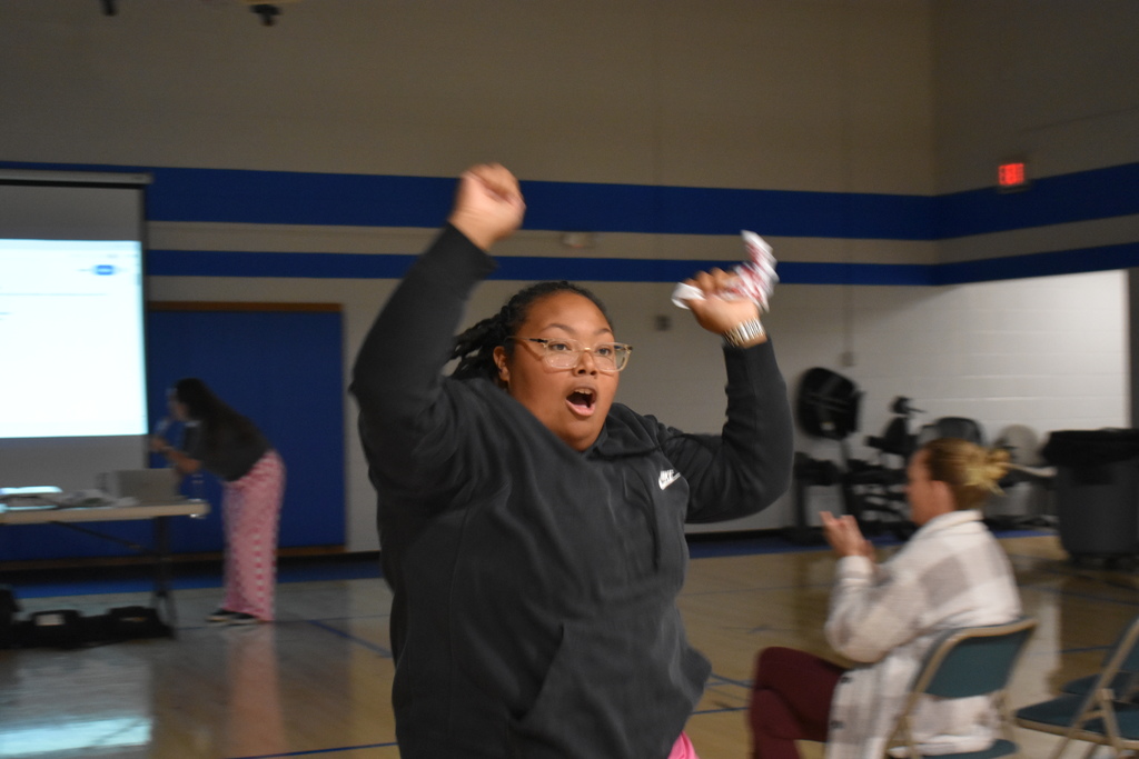 An instructor excitedly running to her team