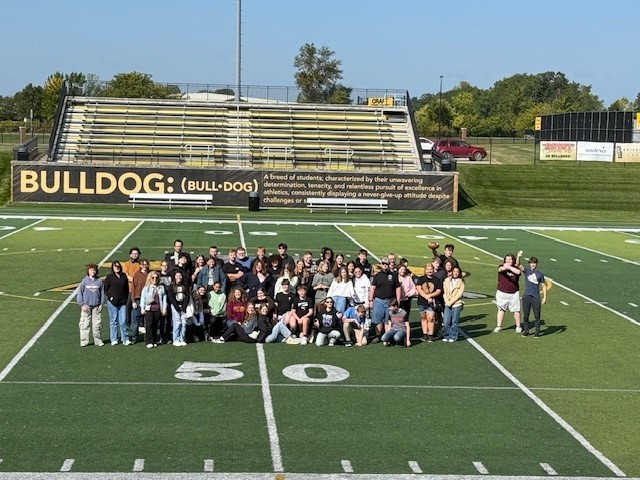 Students on the fifty yard line at Adrian College