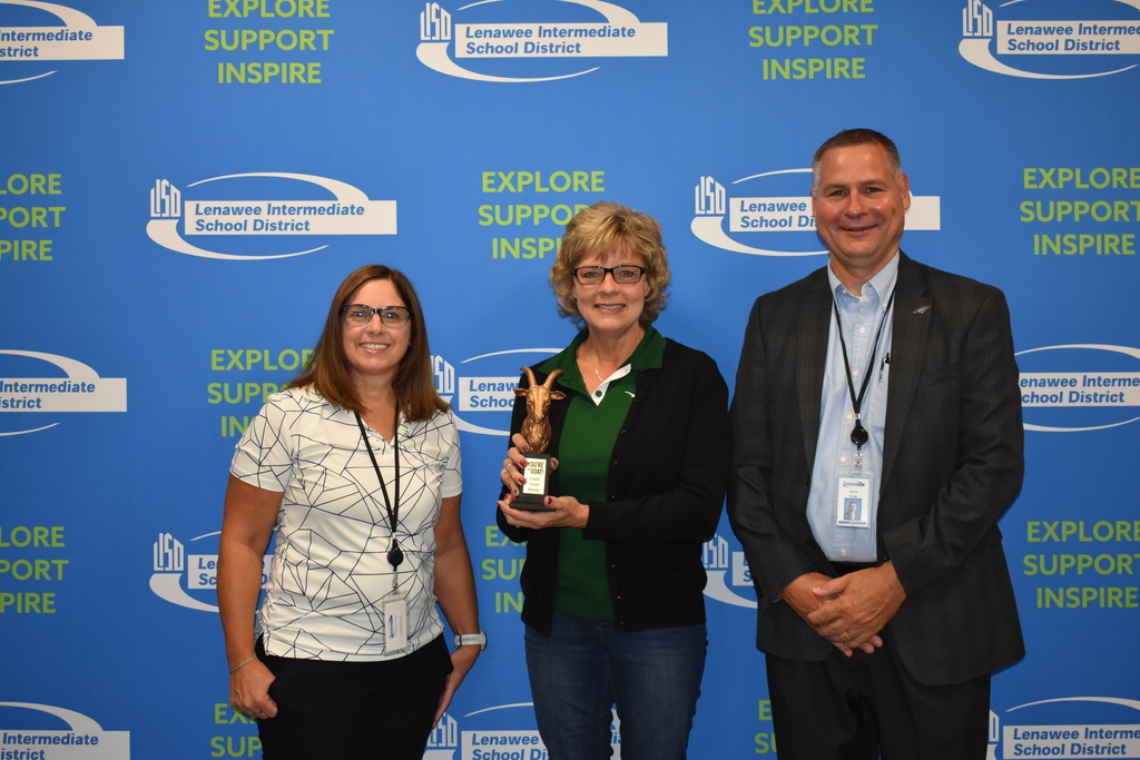 three staff with trophy