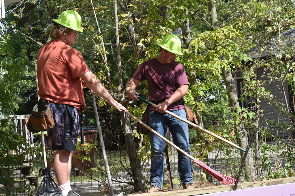 Two students raking