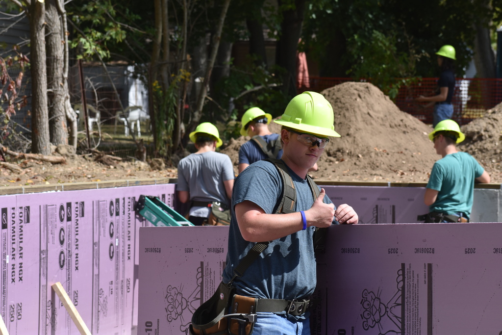 A student giving the thumbs up to the camera on the job site