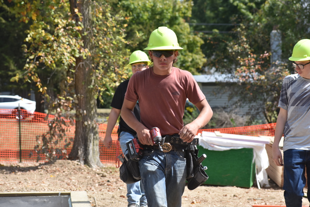 A student walking toward the camera on the job site