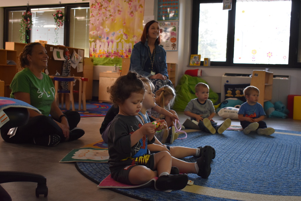 Preschool students learn to settle down with some floor time and a little song