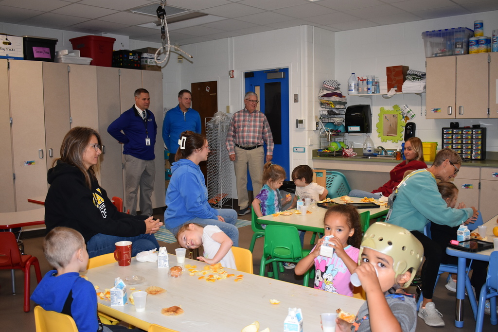 Board members and superintendent visit a preschool room during snack time! 