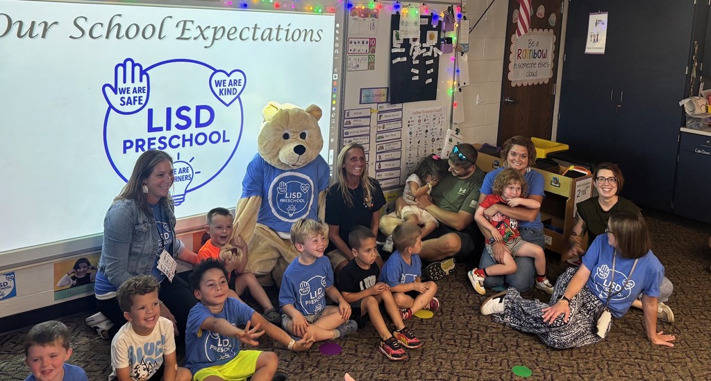 A group of preschoolers with their educators and Barry the Bear