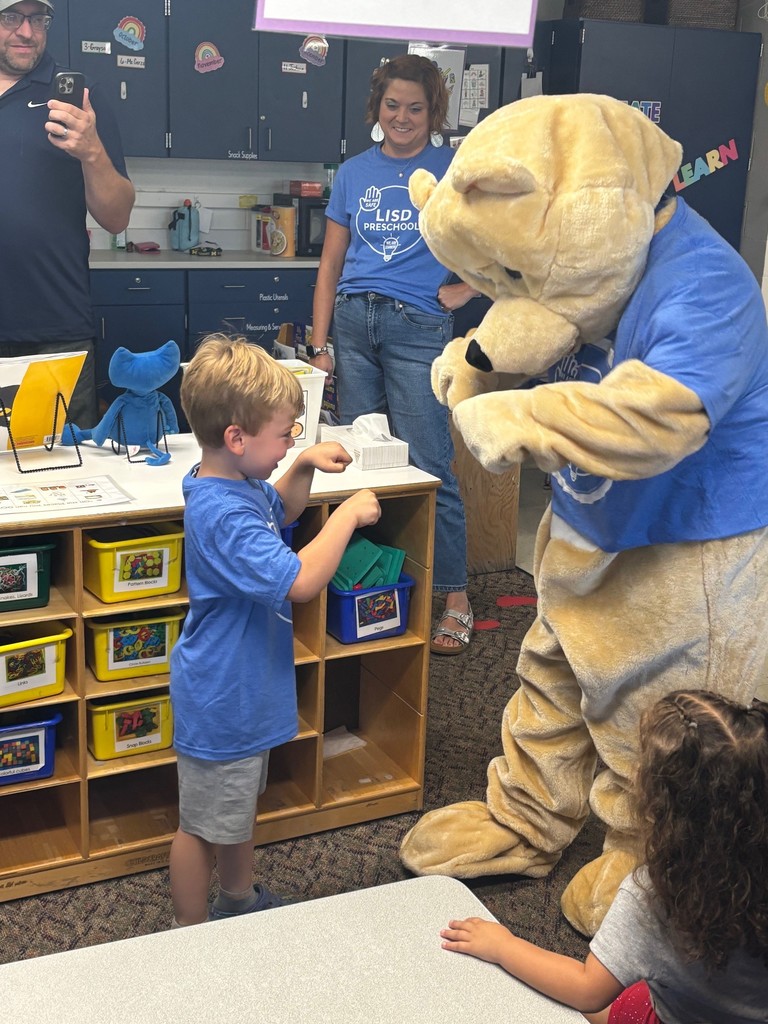 A student fist bumping Barry