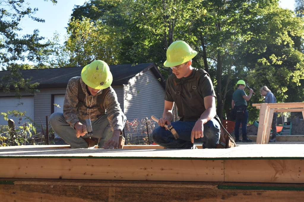Students nailing down a board