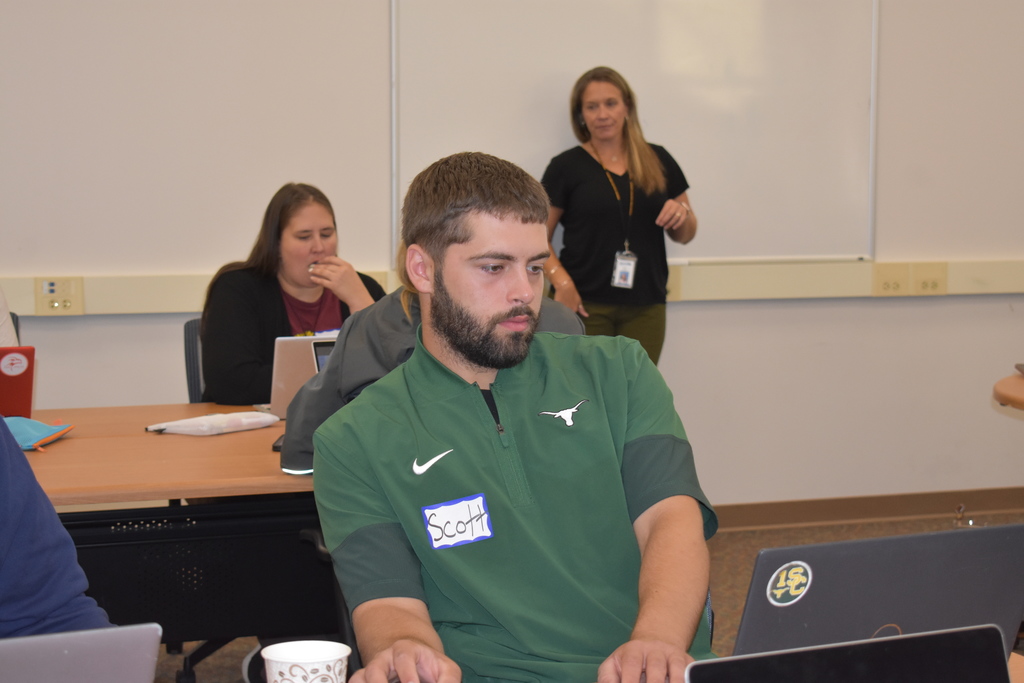 A teacher applying a learning with Ann teaching in the background