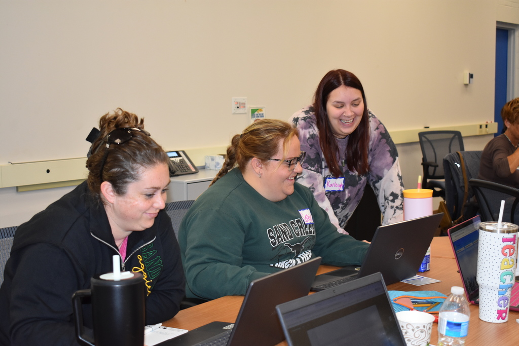 Three teachers laughing and enjoying a training