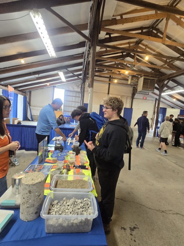 A student talking to an employee in the trades