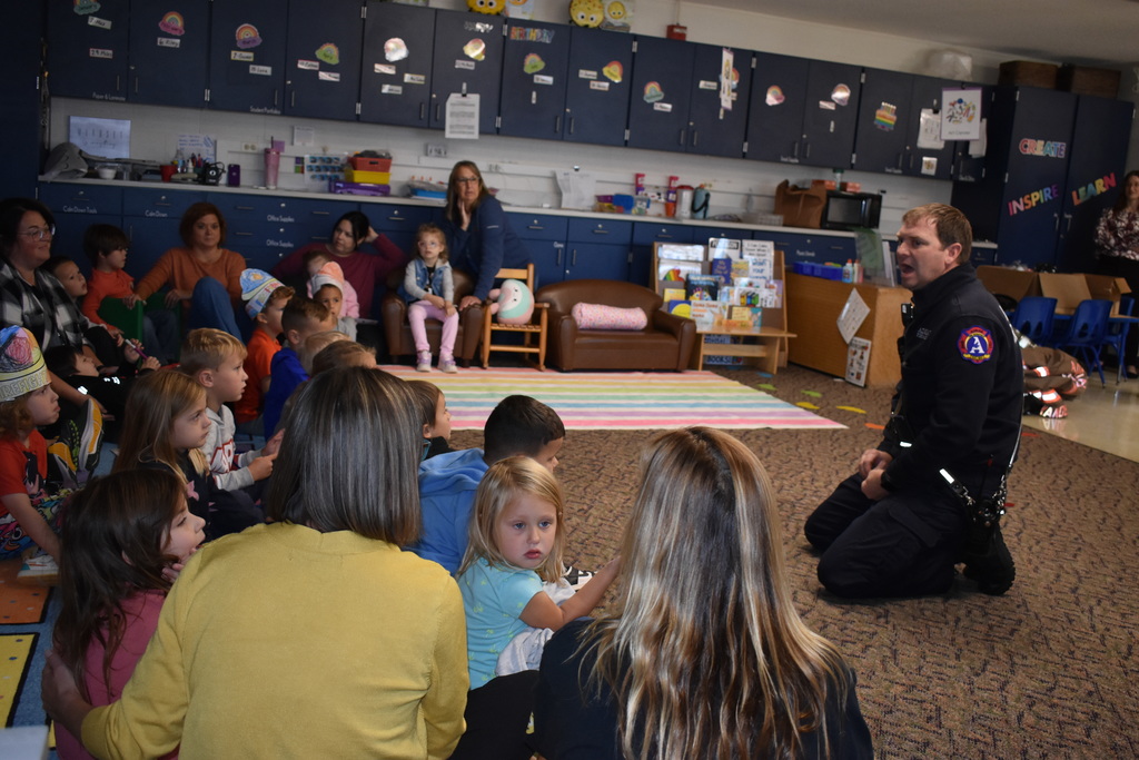 A firefighter chatting with the students about fire safety