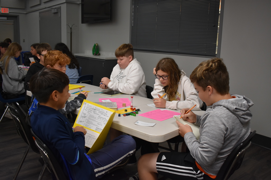Students prepare their calculations at the table