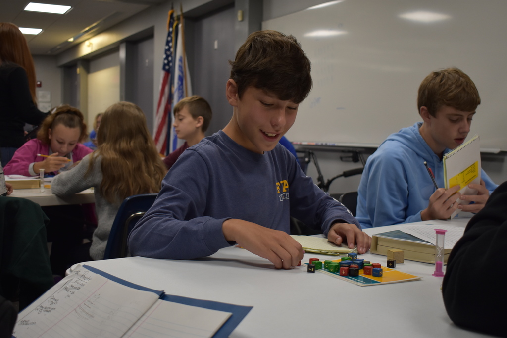 A student smiles as he makes his move