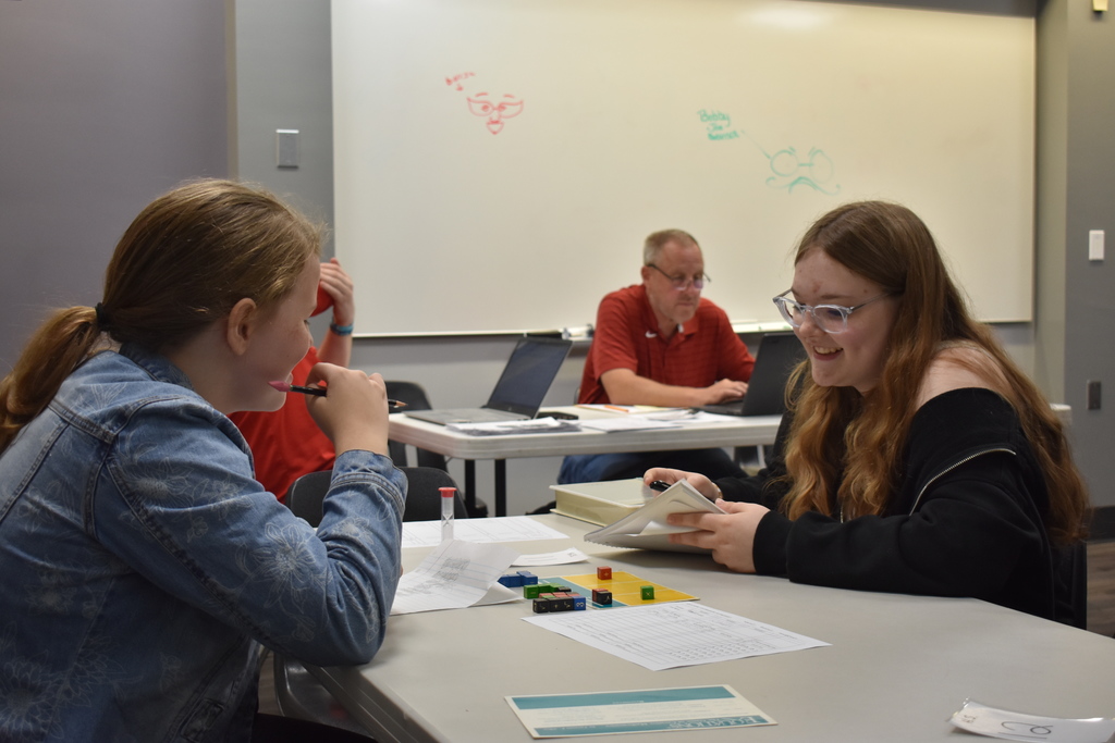 Two students laugh about a move just made