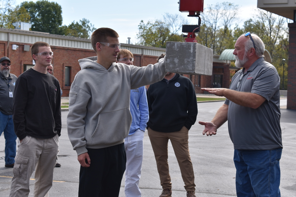 A student practices with the mule as others watch and listen