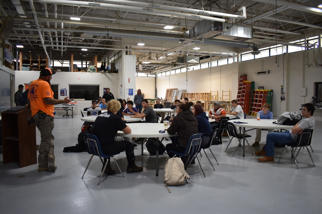 Students in the classroom listening to the speakers