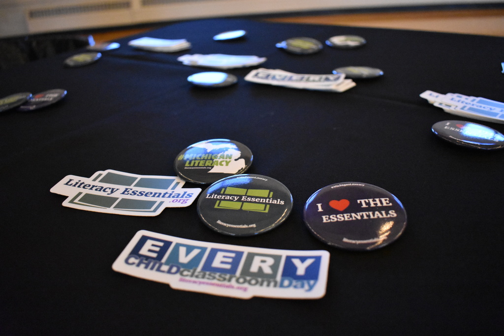 Literacy Essentials buttons and stickers on the table