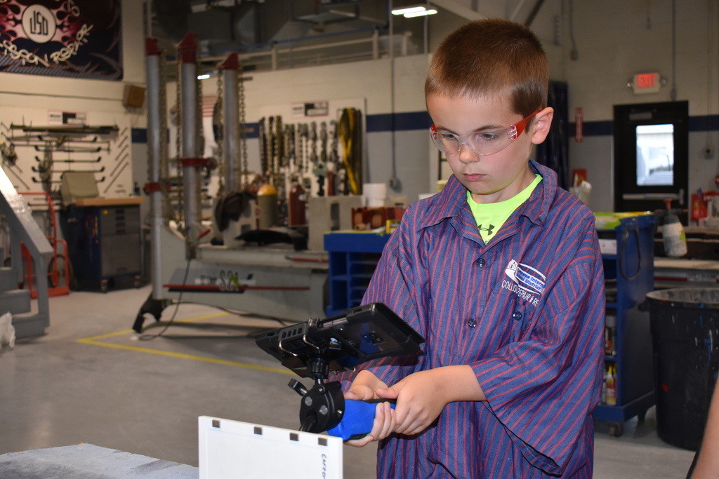 A student uses technology in Automotive Collision