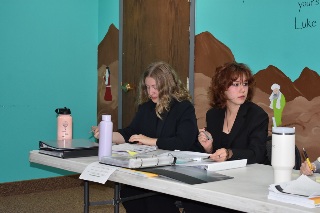 Two students listen to their opposition make his case