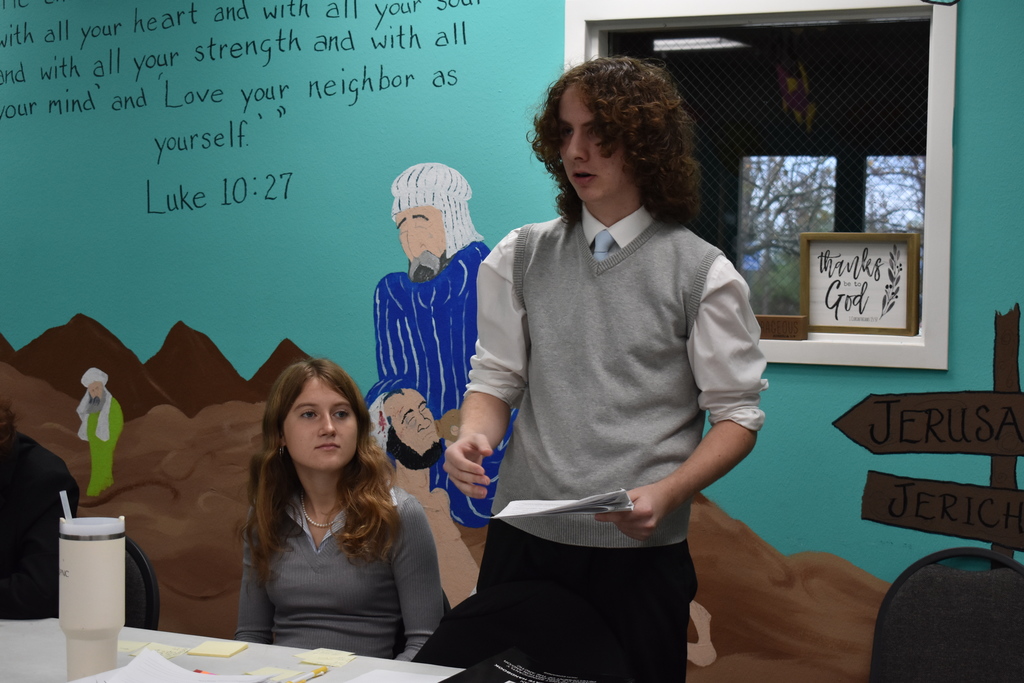 A student makes his affirmative case while is partner listens in 