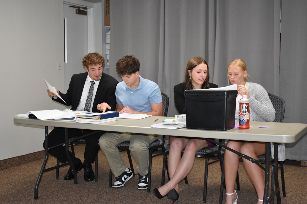 Four students prepare their arguments
