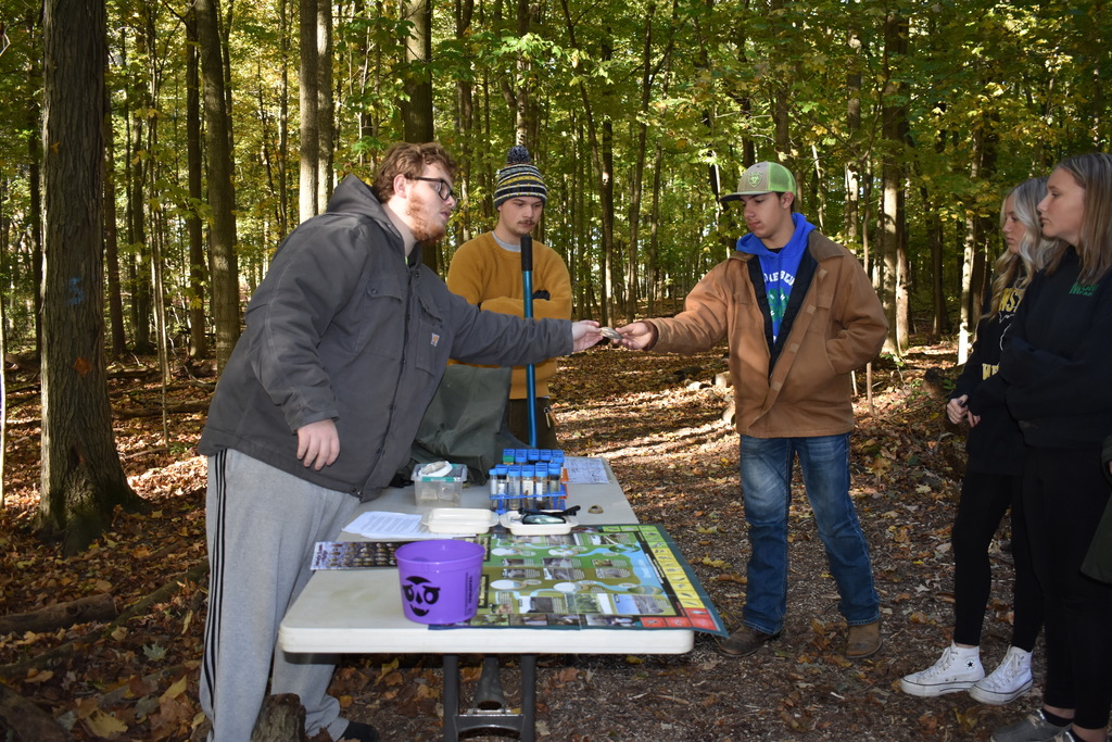 Student handing part of the demonstration to another student