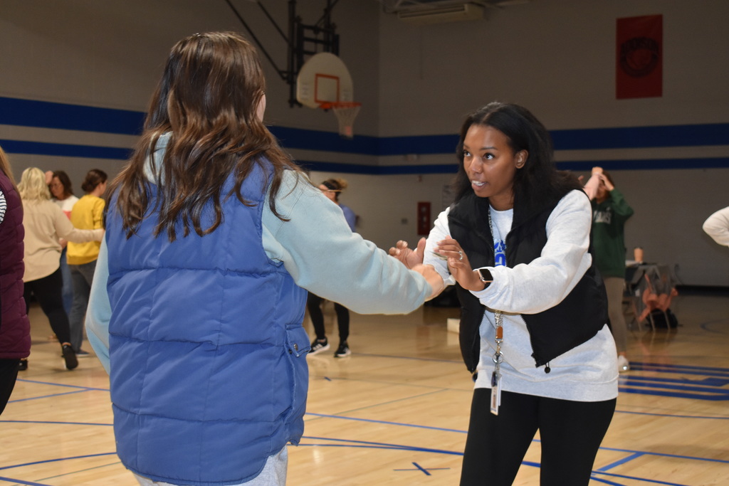 Two employees practicing the move to escape