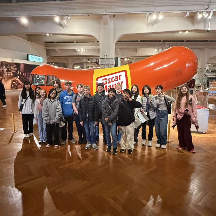 student posing with the Oscar Meyer Iconic hotdog 