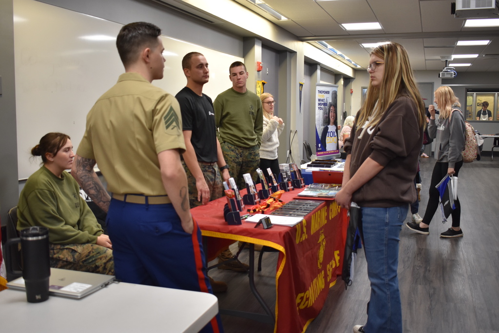 A student chats with the Marines