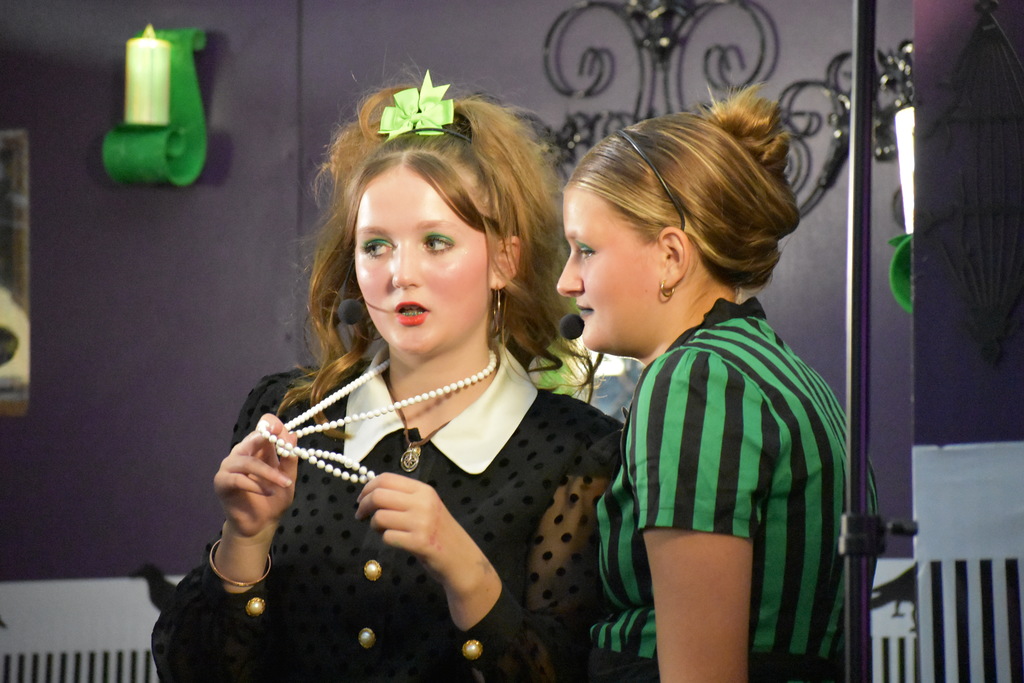 Two students on set during the play