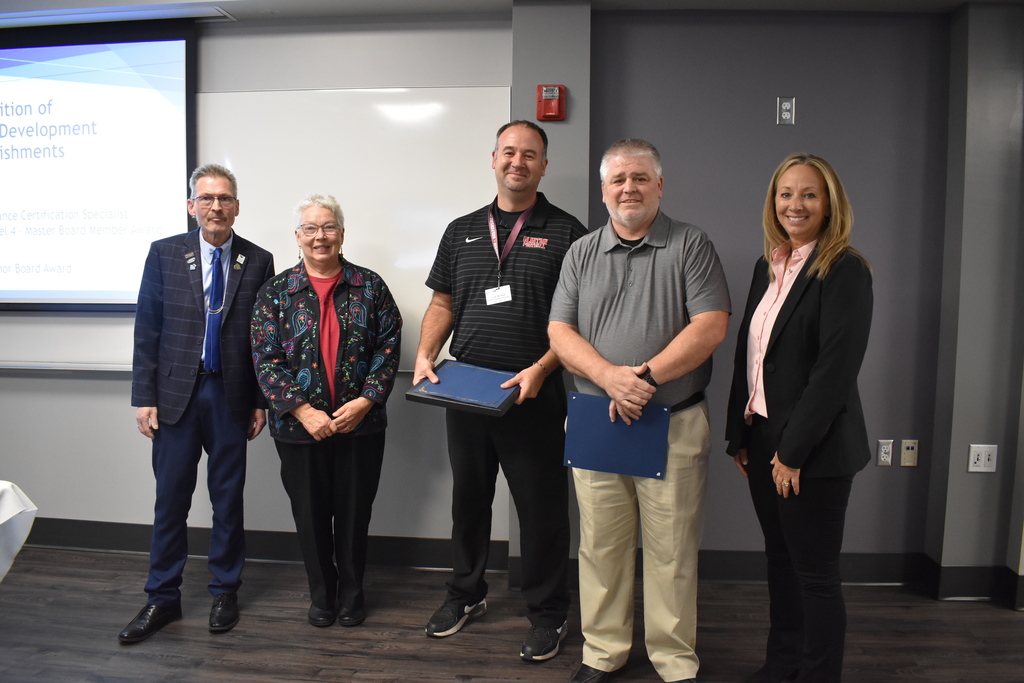 Clinton school board members receiving their award