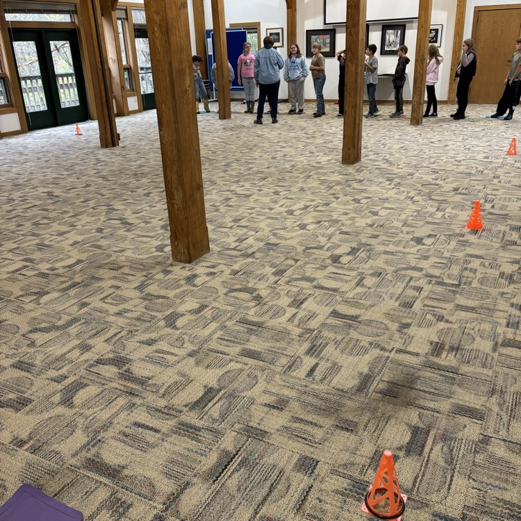 students stand and listen about habitat conditions