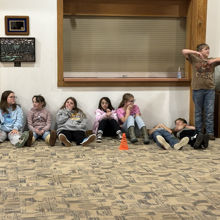 students sit on the ground in “birdie heaven” waiting to get back in the action