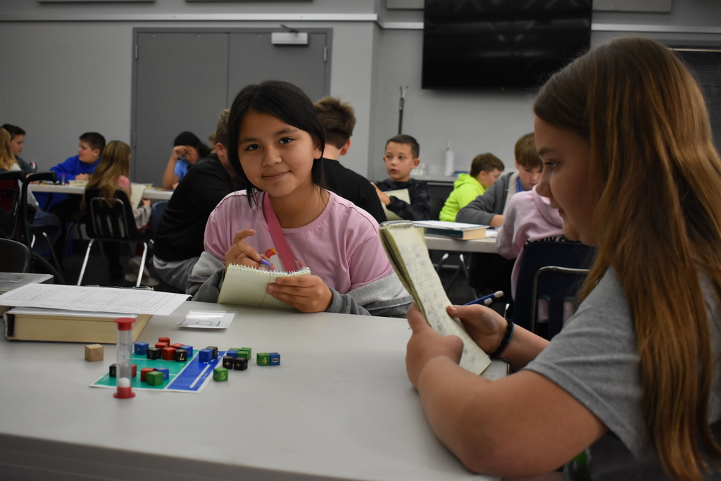 two students playing equations