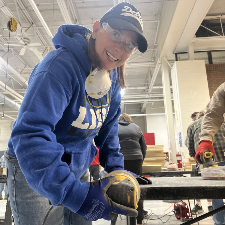 a person sanding a board
