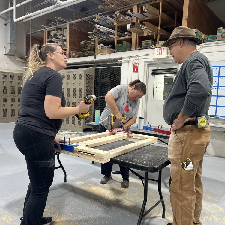 people screwing a bed together