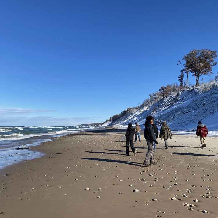 students walking along the beach