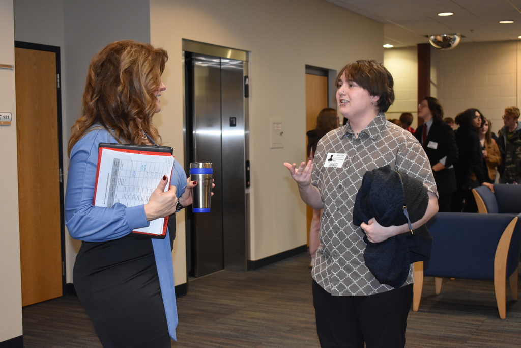 An alum speaking with staff