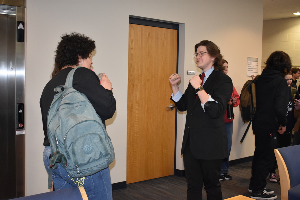 An alum chatting with students
