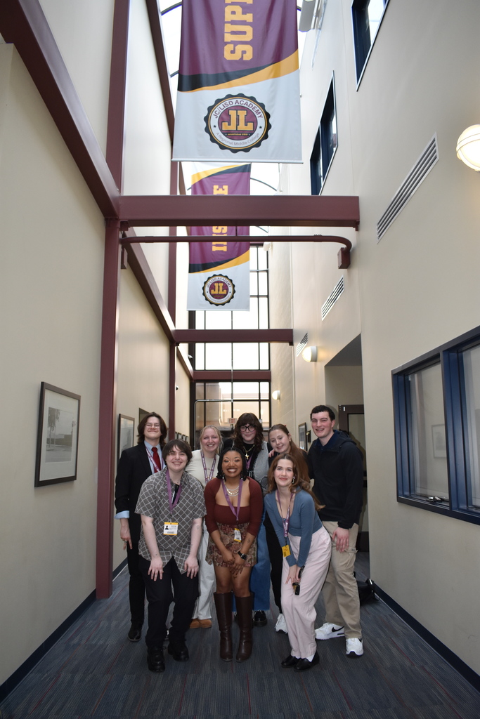Alumni with banners showing