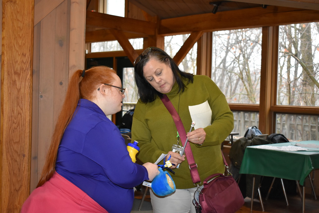 An instructor showing a student an object